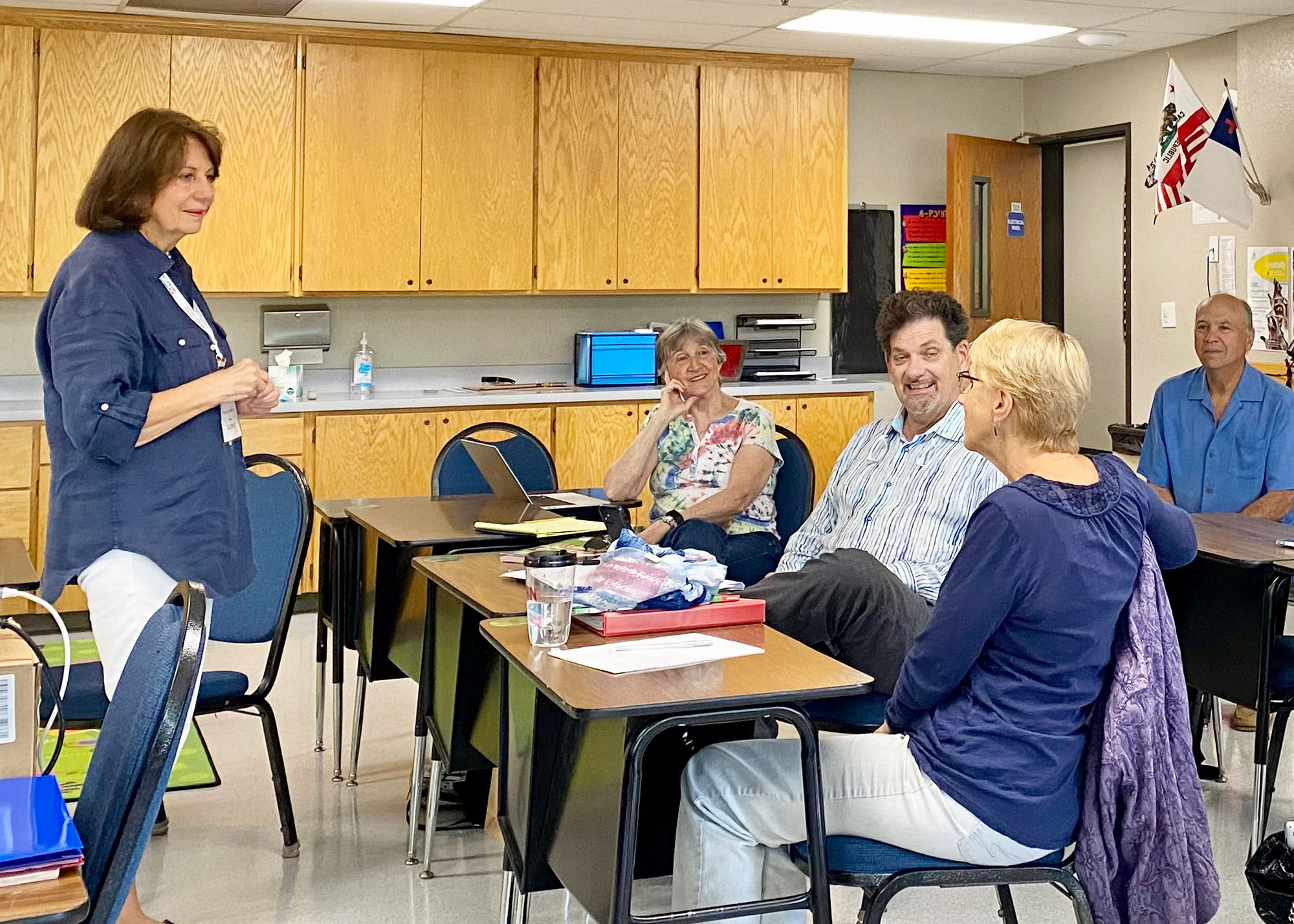 Adult students learning German from their teacher.