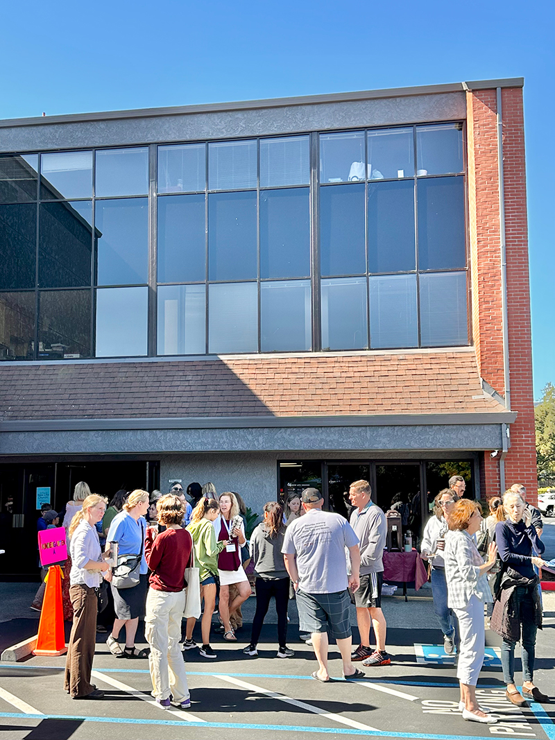 Novato campus building with students milling around.